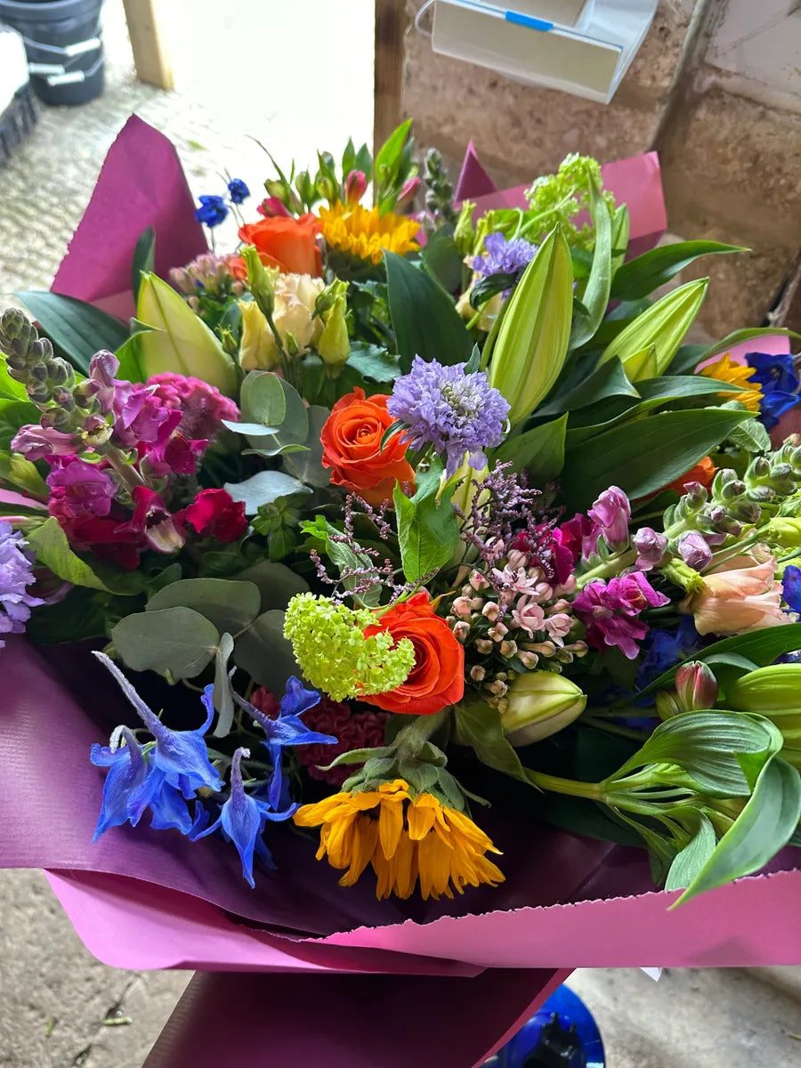 A vibrant bouquet of mixed flowers from A Bunch of Joy by The Flower Pot Swindon LTD, arranged in a colorful floral display.
